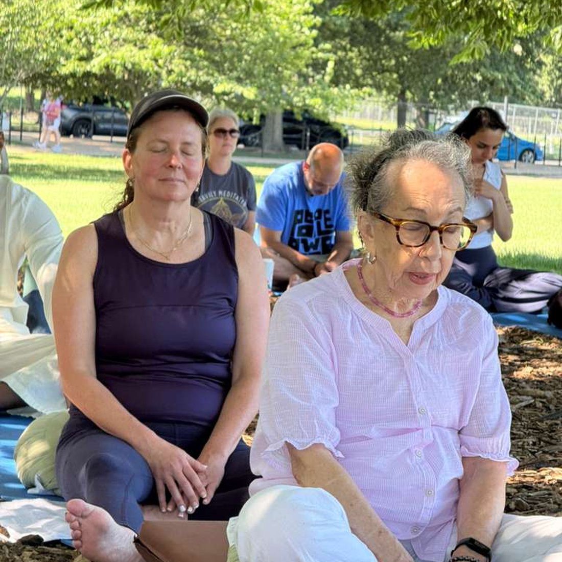 Events Calendar 7 Silent meditators gathering: Community members meditating together outdoors under trees, Buddha Meditation Center DC